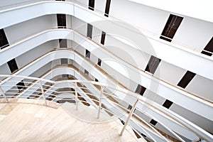 A spiral staircase and white balconies