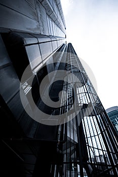 spiral stairs that go up to the top of a big black and black skyscraper