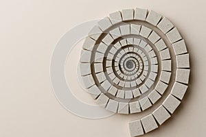 Spiral of stone squares on a light background. Space for text.