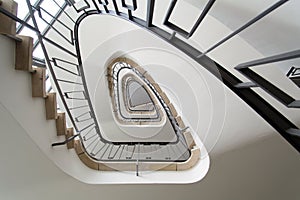 Spiral white staircase from ca 1950. Taken from below with visible black stair railing