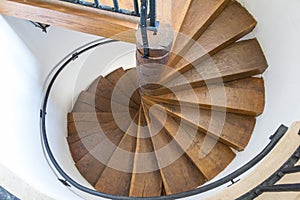 Spiral wooden stairs in the historical Fagaras Fortress on a sunny day. Transylvania. Romania