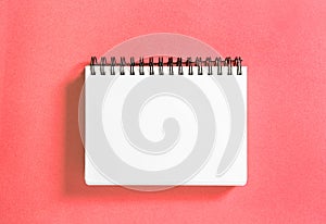 Spirale book coral colored background Paper notebook photo