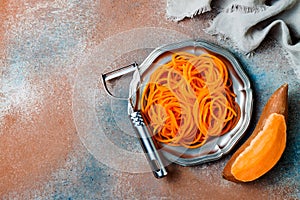 Spiralized sweet potato spaghetti. Low carb vegetable pasta cooking.