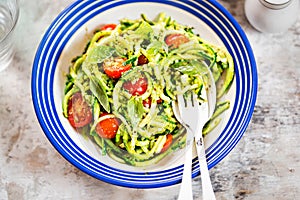 Spiralled courgette with green pesto and cherry tomatoes