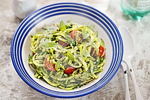 Spiralled courgette with green pesto and cherry tomatoes