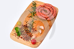 Spiralled, fresh and spicy raw sausages photo