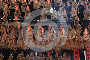 Spirals of incense are hung to the ceiling of a temple (Vietnam) photo