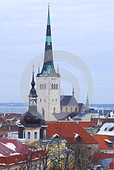 The spire of the church of Oleviste St. Olaf close-up on a cloudy March day. Tallinn