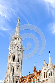 The spire of the famous Matthias Church in Budapest, Hungary. Roman Catholic church built in the Gothic style. Orange colored tile