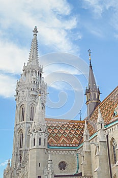 The spire of the famous Matthias Church in Budapest, Hungary. Roman Catholic church built in the Gothic style. Orange colored tile