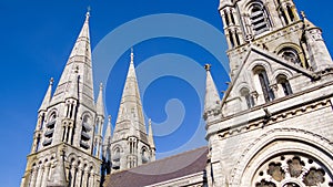 The spires of the Anglican Cathedral of St. Fin Barre in the Irish city of Cork. A Christian church in the Neo-Gothic style. sky.