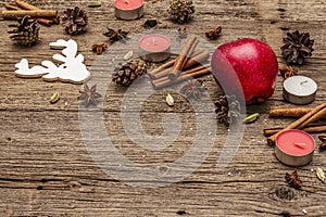 Spirit Christmas background. Apple, candles, spices, deer, cones. Nature New Year decorations, vintage wooden boards