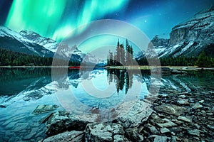 Spirit Island with aurora borealis glowing in the night sky on Maligne Lake at Jasper national park, Canada