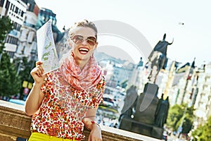 Happy traveller woman on Vaclavske namesti in Prague with map photo