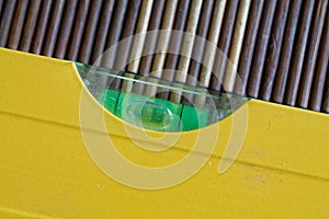 Spirit Yellow level tool close-up, for industrial background or texture