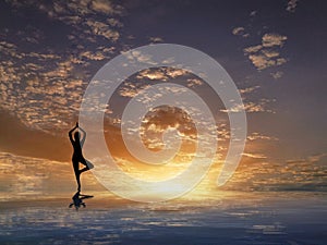 Spiritual background with human silhouette meditating and sunset in sea reflection with copy space for design