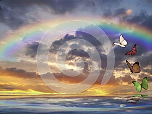 Spiritual background for meditation with clouds sky, rainbow and butterflies