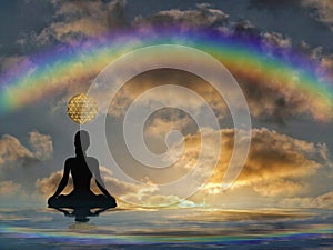 Spiritual background for meditation with human silhouette with rainbow in sea reflection