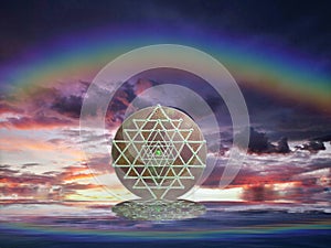 Spiritual background for meditation with sri yantra in clouds sky background with rainbow photo