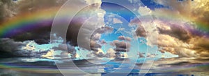 Spiritual background for meditation with stormy clouds and rainbow in sea reflection