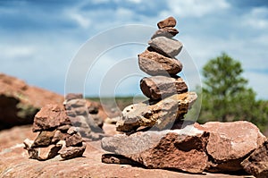 Spiritual cairn of red rocks in the desert