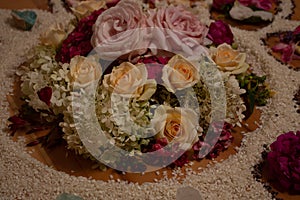 spiritual ceremony with flowers and rice in the shape of a moon, sun, fire and star on a wooden floor, shaman