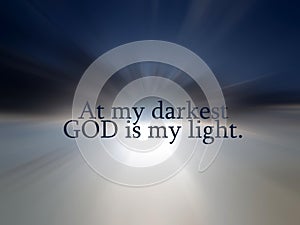 Faith inspirational words - At my darkest  God is my light. With light of heaven and blue sky background. photo