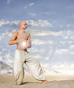 Spiritual Man with Ball of Light Practises Tai Chi