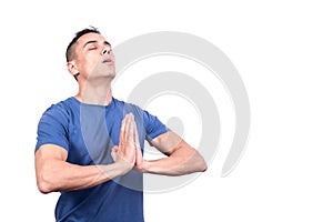 Spiritual man with closed eyes praying concentrated