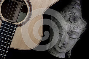 Spiritual music. Buddha meditating with folk acoustic guitar