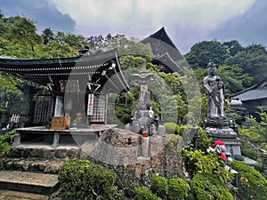 Spiritual Sentinels: Stone Figures Inside Temple in Miyajima, Hiroshima, Japan