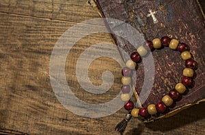 Spiritual still life, an old book and wooden beads