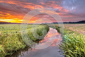 Spiritual voyage concept summer sunrise over lowland river photo