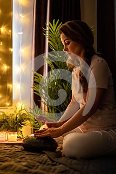 Spiritual yoga woman playing melody on glucophone practice mindfulness harmony balance at bedroom