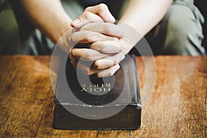 Spirituality and religion, Hands folded in prayer on a Holy Bible