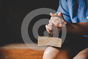 Spirituality and religion, Hands folded in prayer on a Holy Bible