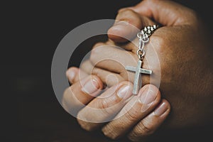 Spirituality and religion,Women in religious concepts Hands praying to God while holding the cross symbol. Nun caught the cross in