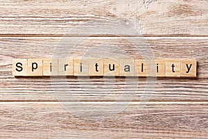 Spirituality word written on wood block. Spirituality text on table, concept