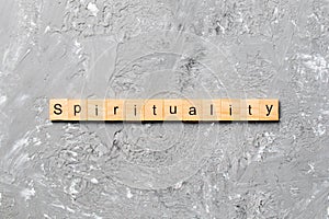 Spirituality word written on wood block. Spirituality text on table, concept