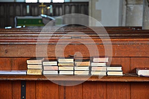Spiritually Uplifting Hymn books stacked on church bench photo