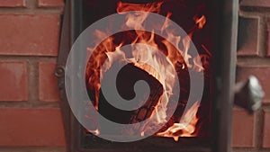 Spirts of flame in furnace with door opened. Slow motion view