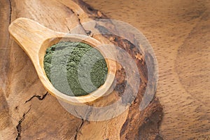 Spirulina powder on the rustic background Spirulina