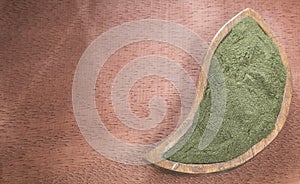 Spirulina powder on the rustic background Spirulina