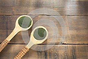 Spirulina powder on the rustic background Spirulina