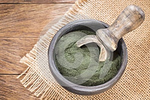 Spirulina powder on the rustic background Spirulina