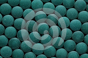 Spirulina tablets close up top view. Flat lay Healthy food supplement. Super food ingredient. top view