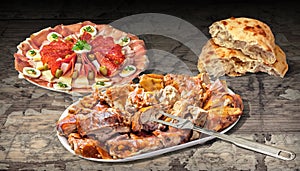 Spit Roasted Pork Meat Slices and Welcome Appetizer Dish Meze with Pita Leavened Flatbread on Weathered Wooden Vignette Background