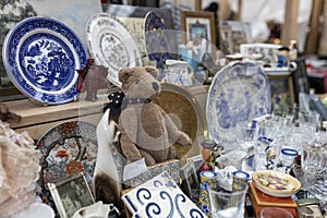 Spitalfields Antic Market. Display. Vintage teddy bear among antique items