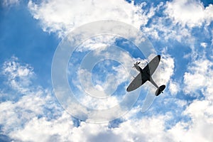 Spitfire on blue cloudy sky