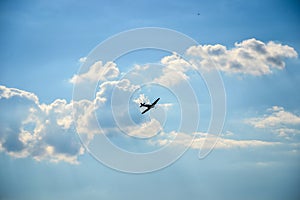 Spitfire in flight on blue cloudy sky